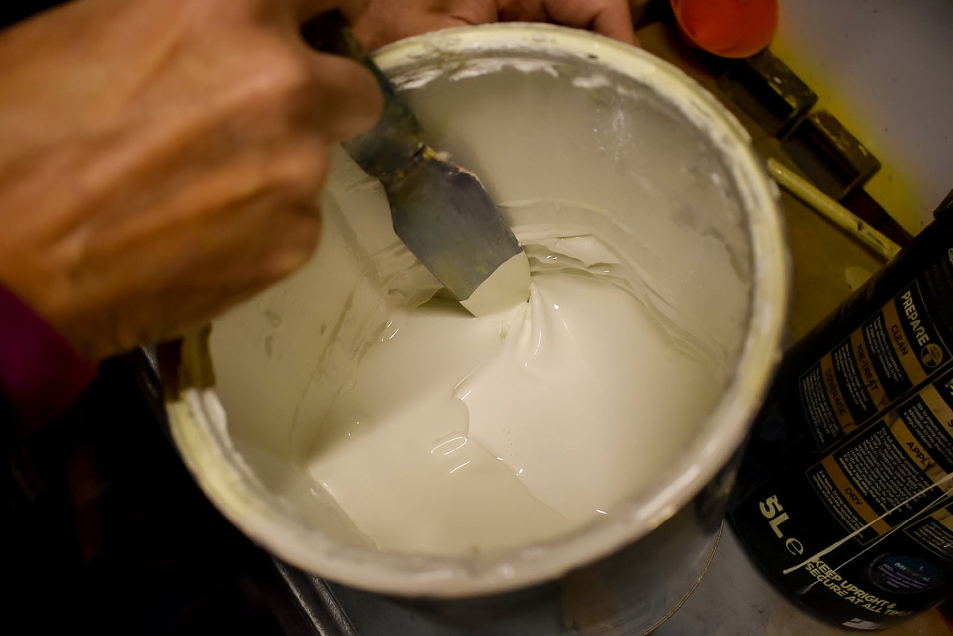 Removing paint skin from paint before straining