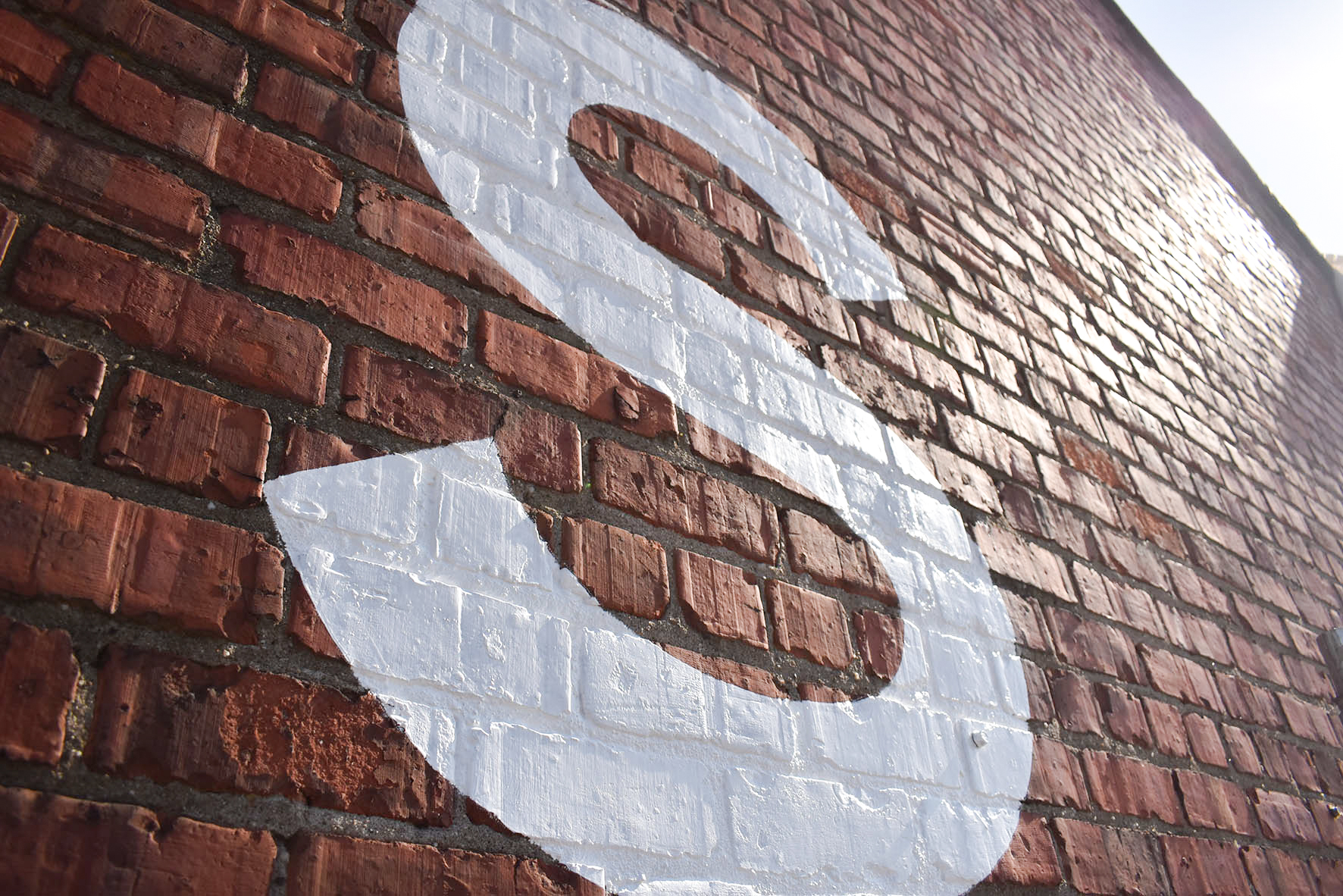 Large painted sign on brick walls in Dundee