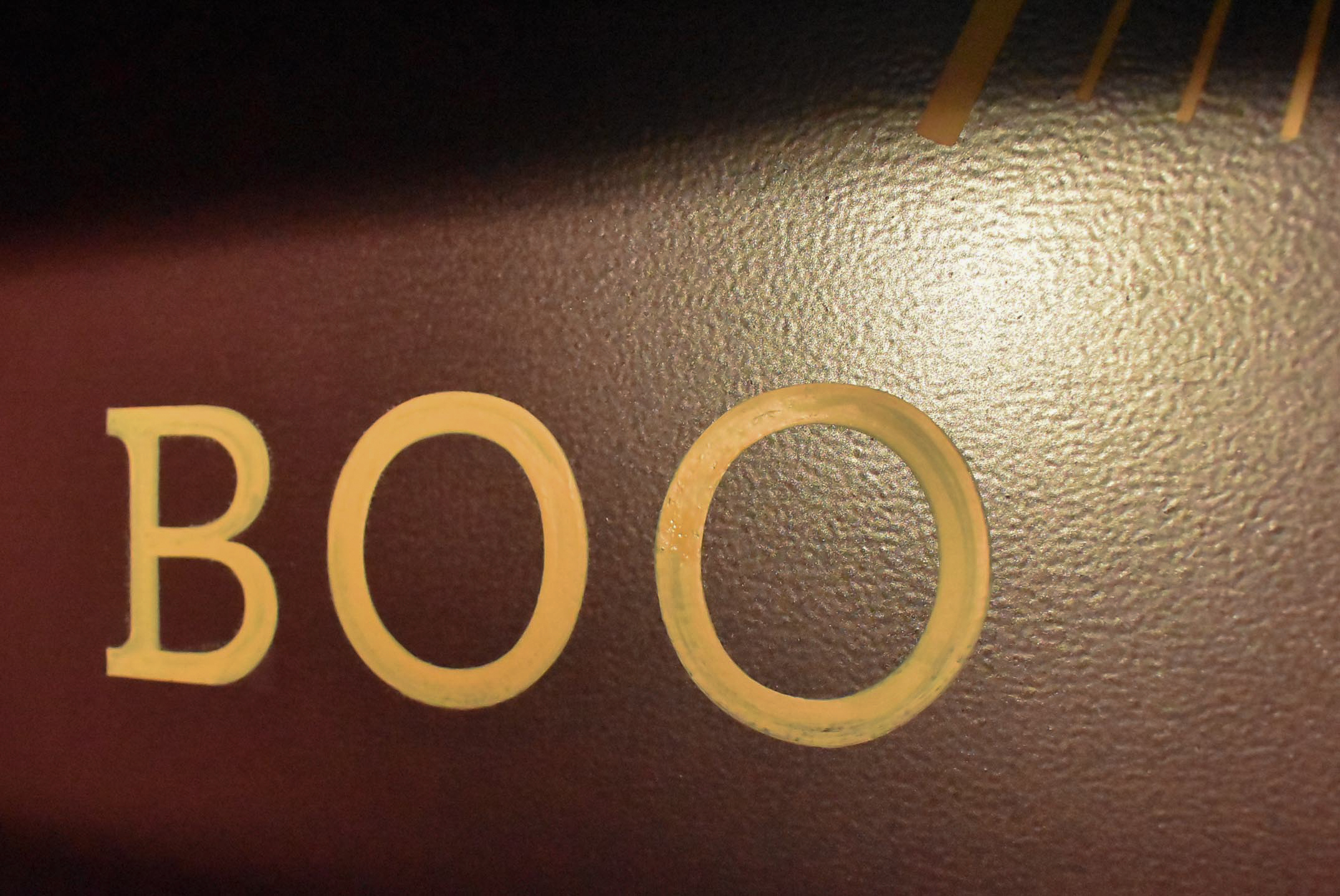 Hand painted lettering on a projecting sign for retailer in Dundee