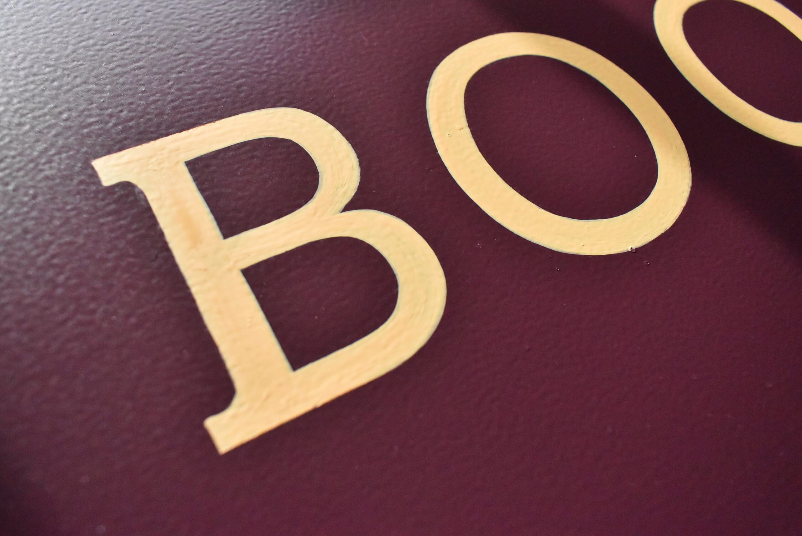 Painted letters on a sign for a Dundee retailer