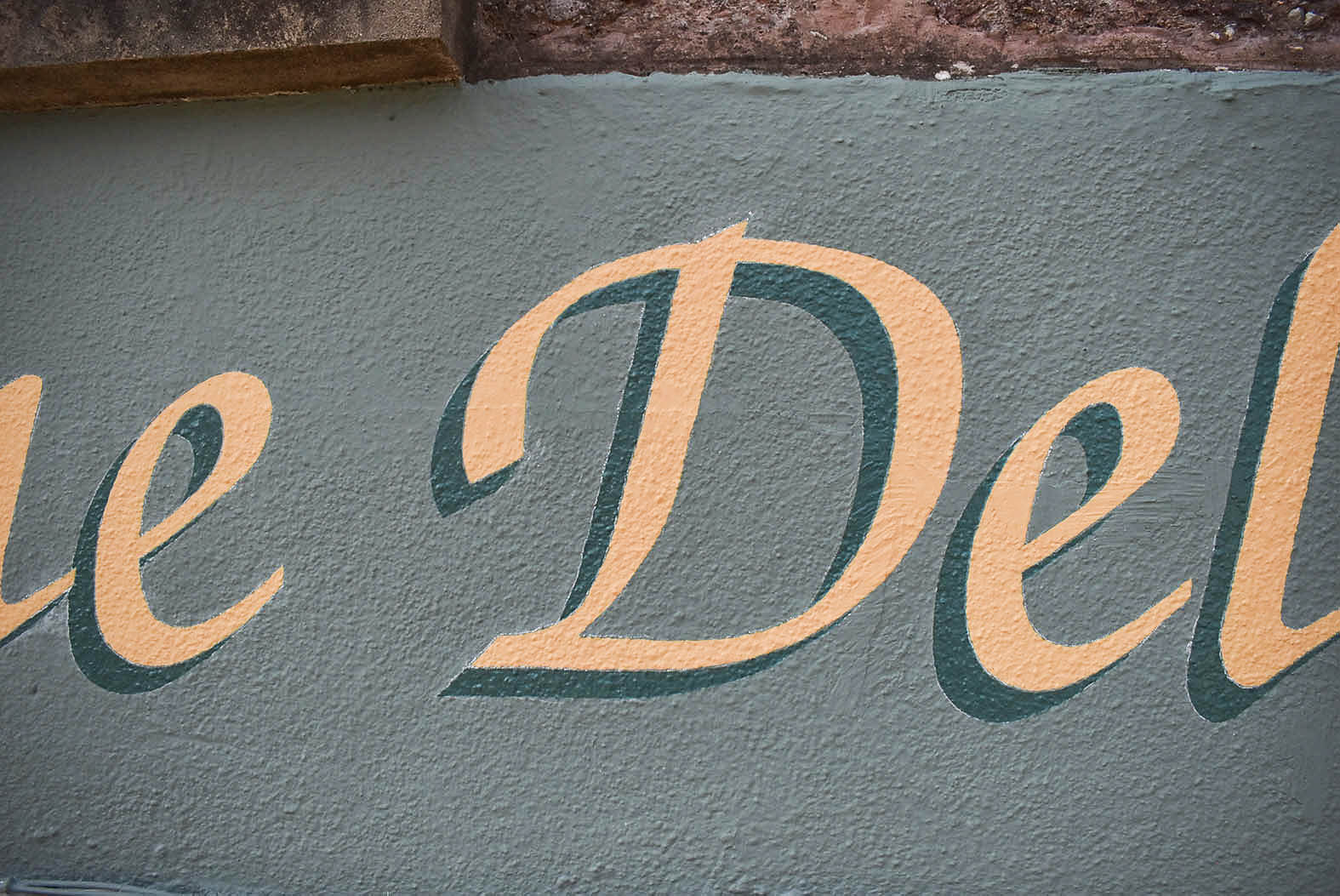 Painting a shopfront sign in north east Scotland